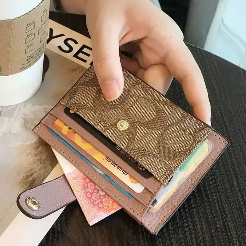 Compact RFID wallet for women held in hand, showcasing cards and cash, perfect for organized essentials.
