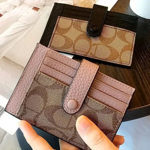 Compact RFID wallet for women in stylish design, featuring card slots and a button closure on a wooden table.