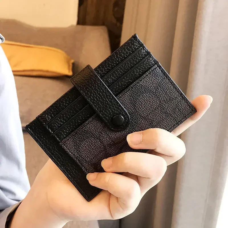 Compact RFID wallet for women in black, held in hand, showcasing slim design and card slots.