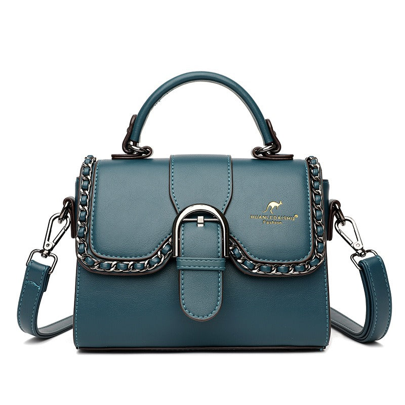 Luxury PU shoulder bag for women in teal with chain detail and magnetic buckle closure.